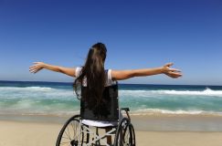 girl in wheelchair on beach